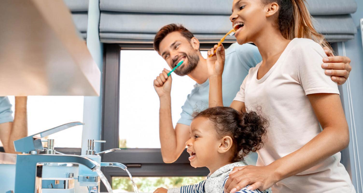 family brushing their teeth together