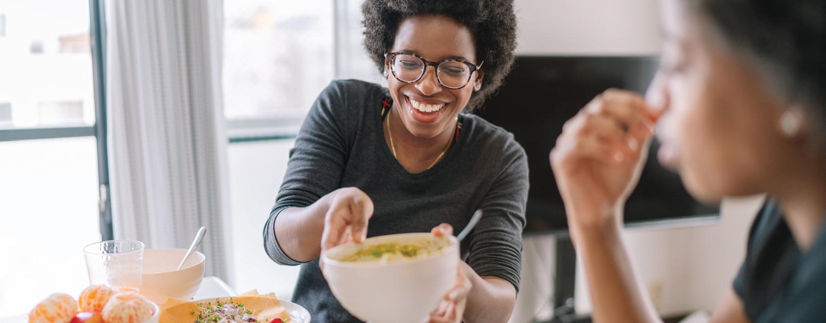 people eating and passing a bowl