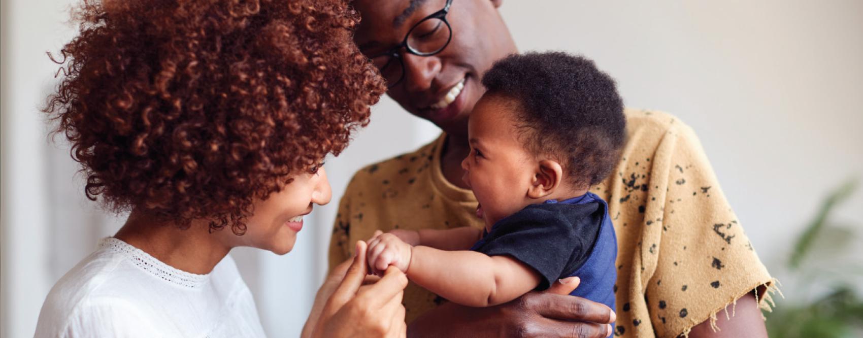 mother and father holding child