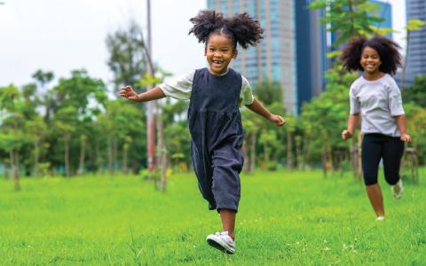 children running in a park smiling